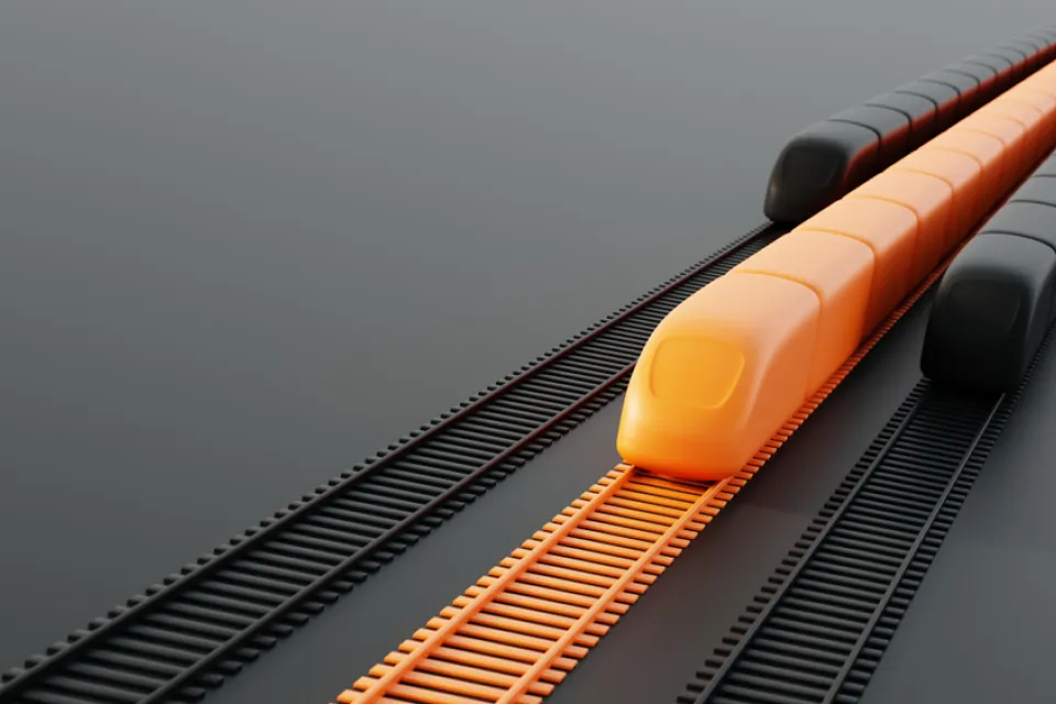 A conceptual rendering of three high-speed rail trains. The middle train is orange; the other two are black.